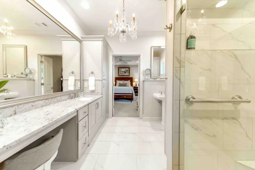 New bathroom built by Trick Construction with a large marble counter, marble shower, and marble flooring.
